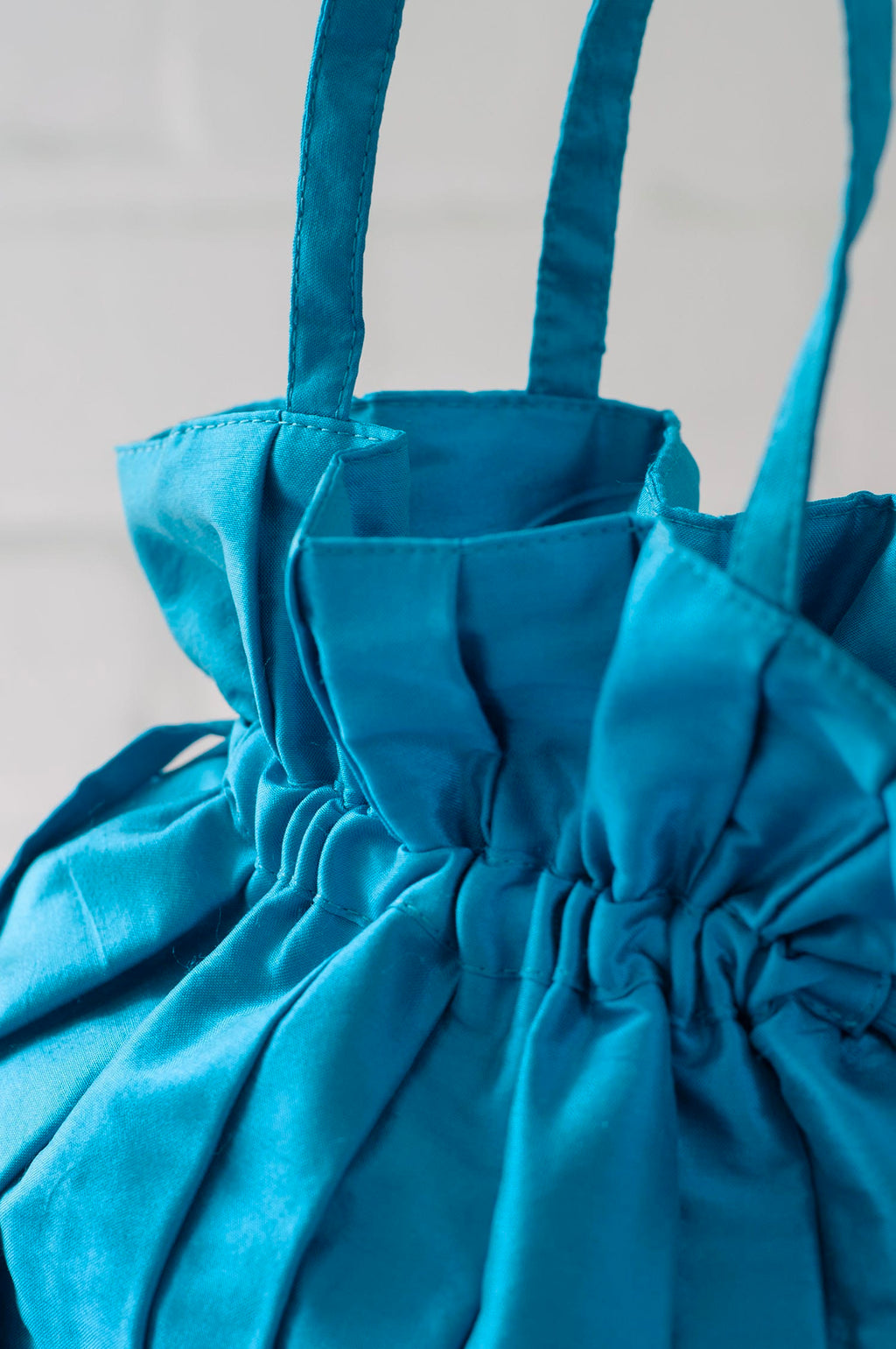 Dollis Goods Drawstring bag Occasion Bag in Aqua Blue