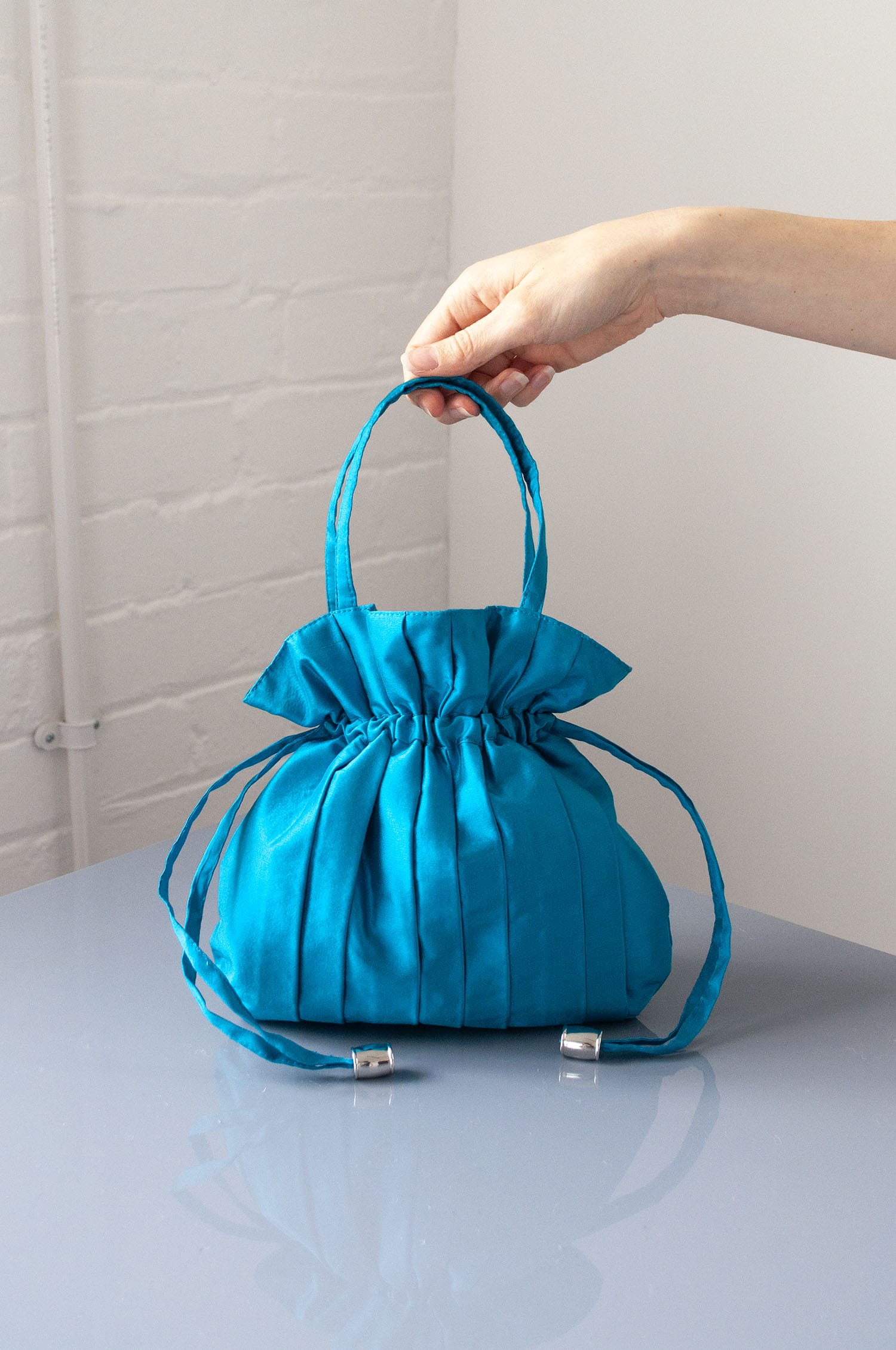 Dollis Goods Drawstring bag Occasion Bag in Aqua Blue